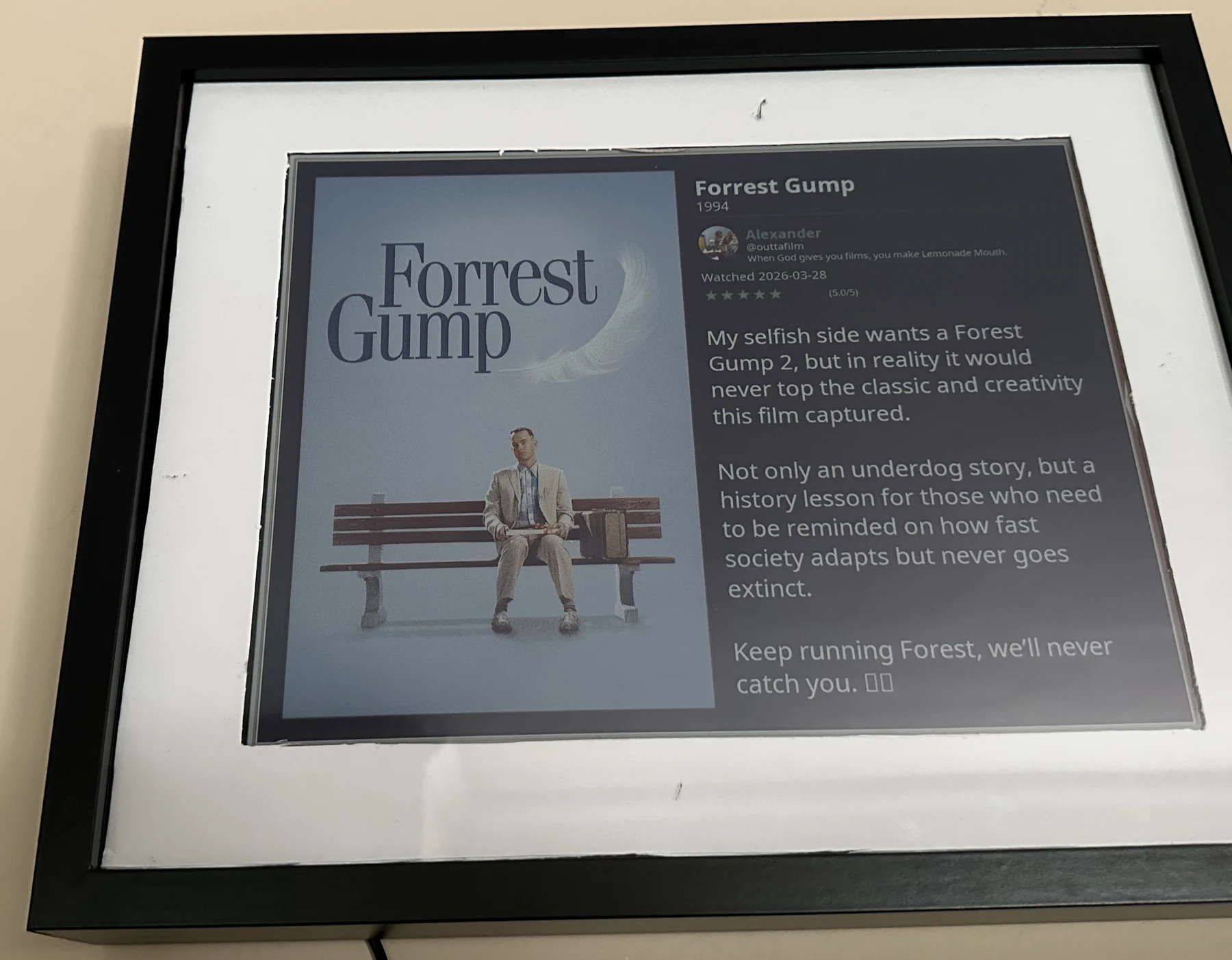 The Matinee display framed on a wall, showing a five-star Forrest Gump review