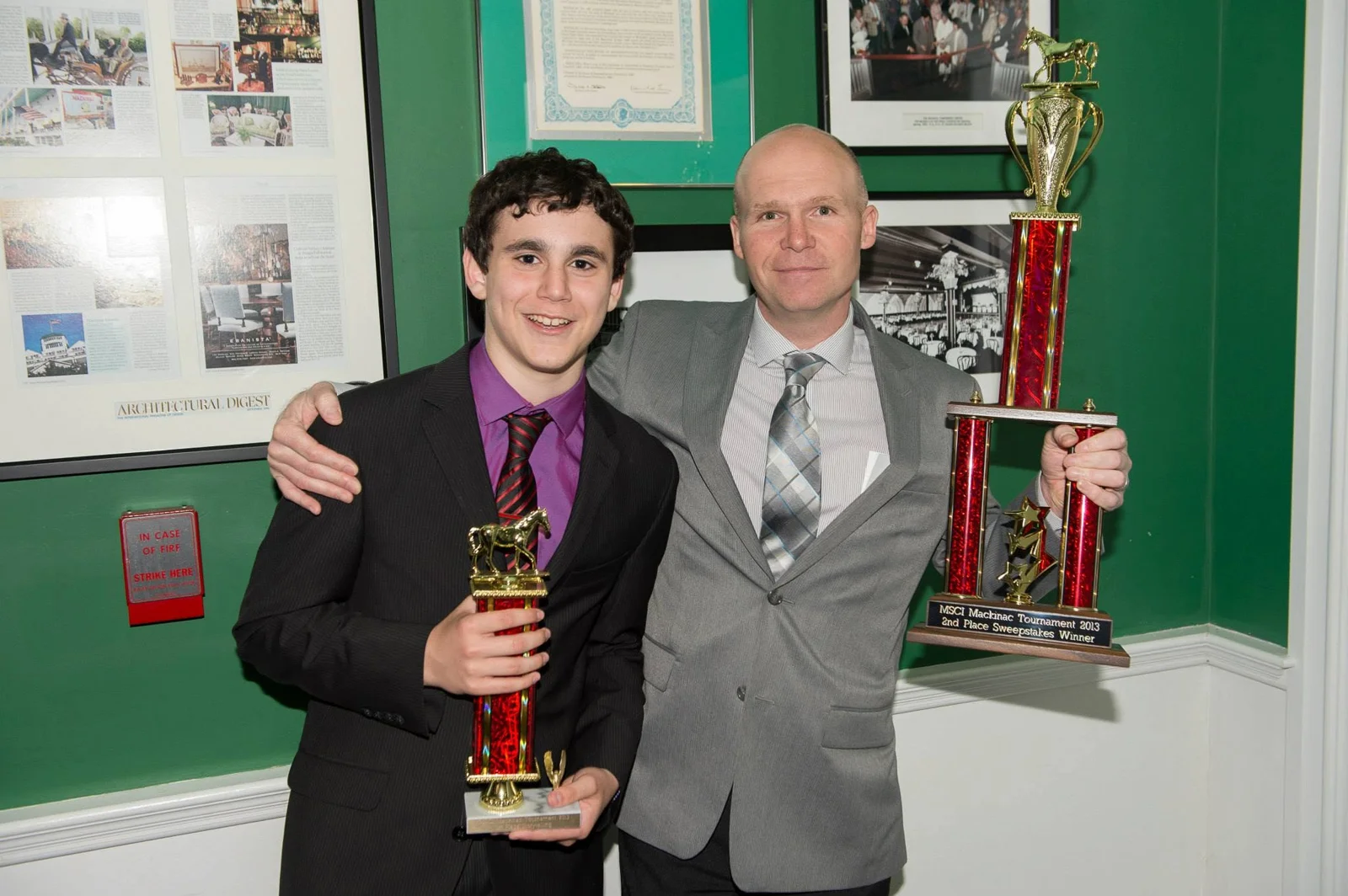 A young Sam Bloch with coach Doug 'Bev' Bevier, both holding trophies at the MSCI Mackinac tournament